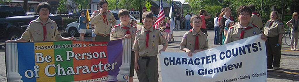 Character Counts banner held by Boy Scouts